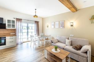 a living room with a couch and a table at Ferienbahnhof Fichtental Gleisblick Lounge in Prackenbach