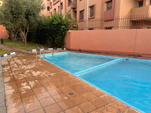 a swimming pool in front of a building at Marrakech Sakan Annakhil im6 n31 in Marrakesh +8 photos