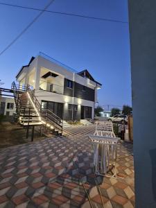 a building with stairs and tables in front of it at Victoria Houses, Vlore Albania in Vlorë