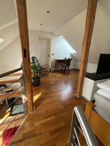 a living room with a staircase and a table at Beautiful studio apartment in Nordhausen