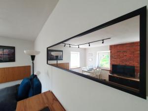 a living room with a large mirror on the wall at Apartament Chełmsko Śląskie in Chełmsko Śląskie