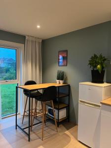a kitchen with a table and chairs and a window at Reine Sea Apartment in Moskenes