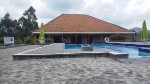 a house with a swimming pool and a building at Mist Stay Inn in Ruhengeri +14 photos