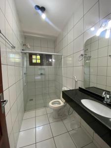 a bathroom with a toilet and a sink and a mirror at Casa em Guaramiranga, ao meio da Natureza! in Guaramiranga +31 photos