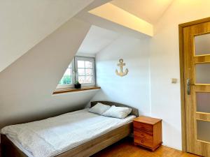 a small bedroom with a bed and a window at Pokoje przy SKM Sopot Wyścigi in Sopot +21 photos