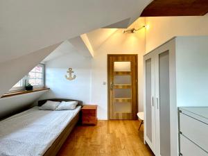 a small bedroom with a bed and a window at Pokoje przy SKM Sopot Wyścigi in Sopot