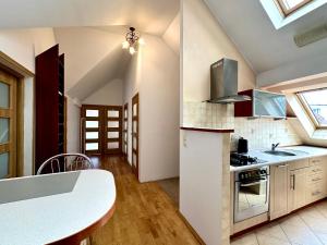 a kitchen with a sink and a stove top oven at Pokoje przy SKM Sopot Wyścigi in Sopot