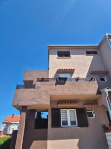 a tall building with a window on the side of it at Zumbul in Zadar