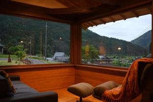 a room with two chairs and a large window at Nantan - House - Vacation STAY 82583v in Ōno +6 photos