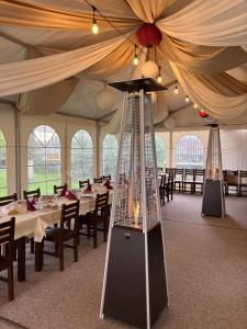 a tent with tables and chairs and a ceiling at Fodor Ház in Miercurea-Ciuc