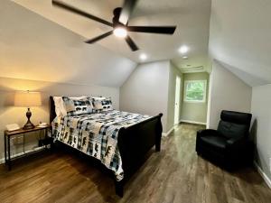a bedroom with a bed and a ceiling fan at Above the Clouds Cabin in Franklin