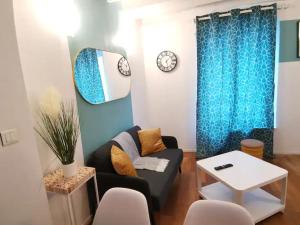 a living room with a couch and a table at Charmant appartement au coeur de Château-Thierry in Château-Thierry
