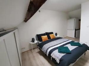 a bedroom with a large bed in a white room at Charmant appartement au coeur de Château-Thierry in Château-Thierry +6 photos