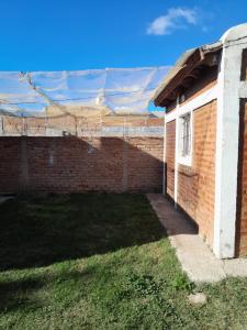 a brick building with a roof on top of it at Dpto en San Luis Capital in San Luis