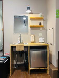 a desk with a sink and a tv in a room at Wasabi Mita Hotel - Vacation STAY 84674v in Tokyo