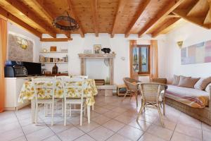 a living room with a table and chairs and a couch at Intera casa Lago di Garda in Brenzone sul Garda