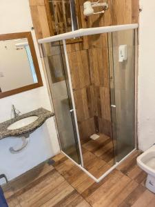 a bathroom with a shower and a sink at Pousada da Janjana in Nova Iguaçu