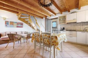a kitchen and dining room with a table and chairs at Intera casa Lago di Garda in Brenzone sul Garda +14 photos