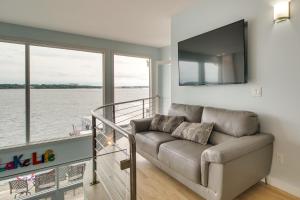 a living room with a couch and a large window at Indoor Pool and Waterfront Deck Spacious Jay Home in Jay