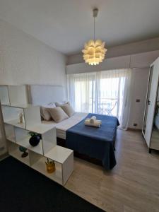 a bedroom with a large bed and a chandelier at Sea view Cascais in Cascais