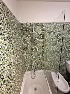 a bathroom with a shower and a tub and a sink at Sea view Cascais in Cascais