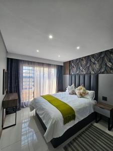 a bedroom with a large bed and a window at Midlands Guest House in Howick