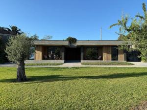 a house with a tree in front of a yard at Perral Nature - Casa do Carvalho - Gerês in Terras de Bouro