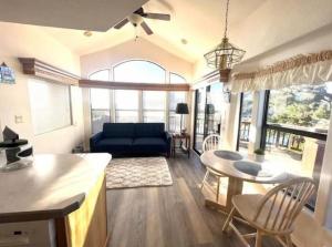 a living room with a blue couch and a table at Rogue River Landing Resort Cabins in Gold Beach