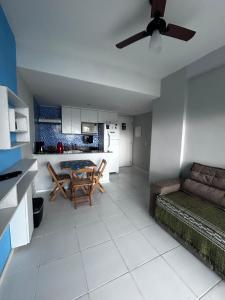 a kitchen and a living room with a ceiling fan at Angra dos Reis Porto Real in Mangaratiba