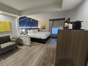 a hotel room with a bed and a television at Comfort Inn & Suites in Saint Louis +30 photos
