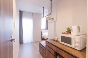 a living room with a microwave on a counter at LANG HOTEL Kameido - Vacation STAY 79485v in Tokyo
