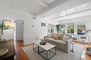 a living room with a couch and a table at The Adaline #2 - Luxury Hyde Park Apt, Steps to Bayshore in Tampa