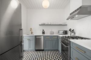 a kitchen with blue cabinets and a stove top oven at The Adaline Room #5 - Upscale Hyde Park Apartment, 1st Floor, Steps to Bayshore in Tampa
