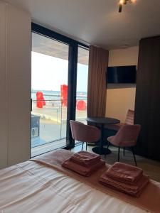 a bedroom with a bed with a view of an airport at El Mirador - Quality Stay in Ostend