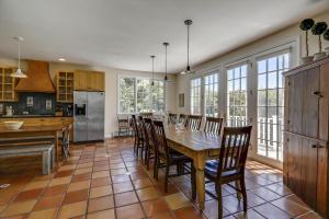 a kitchen and dining room with a table and chairs at Weeks Hill: 5 br, fireplace, a/c, deck, views! in Stowe +22 photos