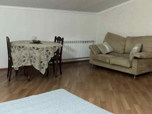 a living room with a table and a couch at Mtskheta Apartment in Mtskheta