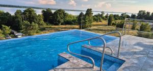 a swimming pool with a view of the water at Lake View Mielno in Mielno
