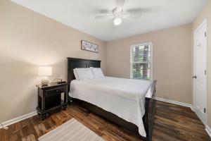 a bedroom with a large bed and a window at 5 Bedroom Mableton Hills Estate in Mableton