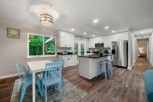 a kitchen with a table and blue chairs in it at 5 Bedroom Mableton Hills Estate in Mableton +9 photos