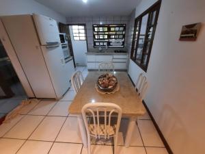 una cucina con tavolo, sedie e frigorifero di Refúgio Souza a Florianópolis Altre 7 foto