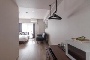 a bedroom with a bed and a living room at LANG HOTEL Kameido - Vacation STAY 76954v in Tokyo