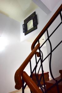 a wooden staircase with a mirror on the wall at Parigi Hotel bed and Breakfast in Santa Cruz de Tenerife