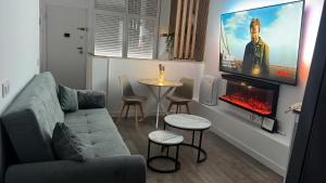 a living room with a couch and a tv at Villa potasa 19 in Madrid