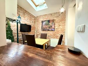 a dining room with a wooden table and chairs at Pokoje na Monciaku 19 in Sopot