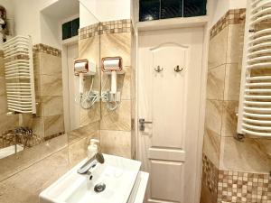 a bathroom with a sink and a shower at Pokoje na Monciaku 19 in Sopot