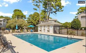 a swimming pool with chairs and a fence at Studio in St James in Southport - great amenities in Southport +11 photos