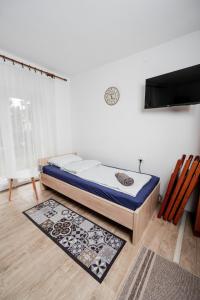 a bed sitting in a room next to a wall at Almádi64 in Balatonalmádi