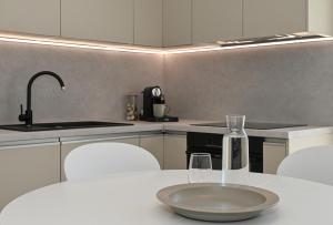 a kitchen with a table with a plate and glasses on it at Casa Dalmacija in Krvavica