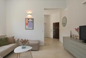 a living room with a couch and a tv at Casa Dalmacija in Krvavica