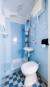 a blue bathroom with a toilet and a sink at Almádi64 in Balatonalmádi +29 photos